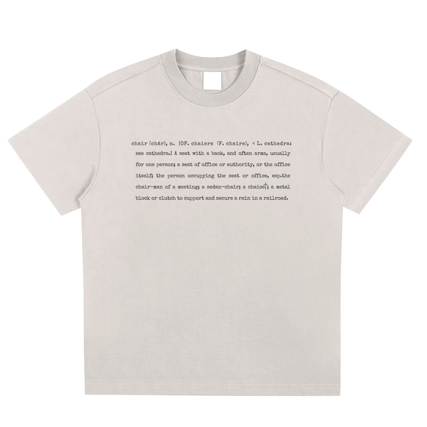 One in three chairs t-shirt image from the front beige t-shirt with the definition of chair printed in typewriter font